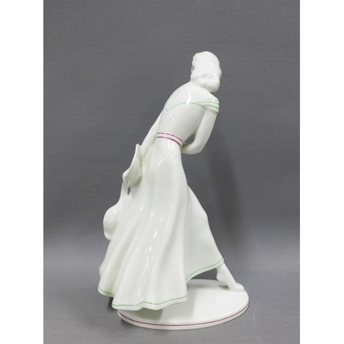 92 - Art Deco porcelain female figure, modelled walking wearing a dress with green and red striped detail... 