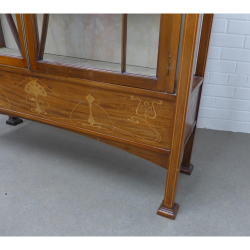 201 - Art Nouveau mahogany inlaid cabinet with an arched top over a pair of glazed doors, with fabric line... 