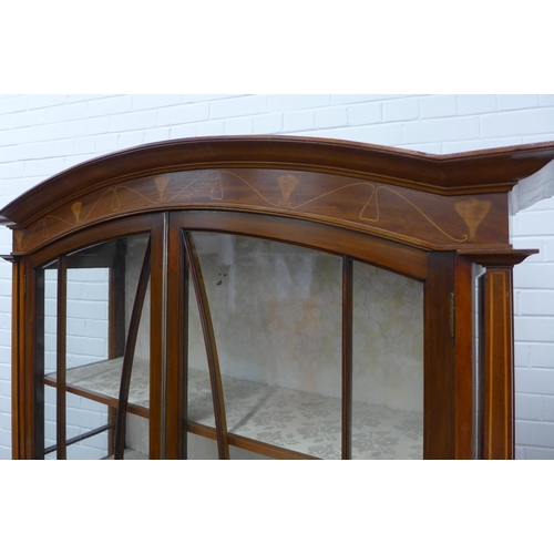 201 - Art Nouveau mahogany inlaid cabinet with an arched top over a pair of glazed doors, with fabric line... 