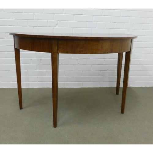 239 - Mahogany demi-lune table on tapering legs. 72 x 123 x 60cm