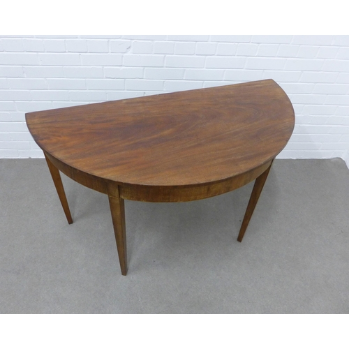 239 - Mahogany demi-lune table on tapering legs. 72 x 123 x 60cm