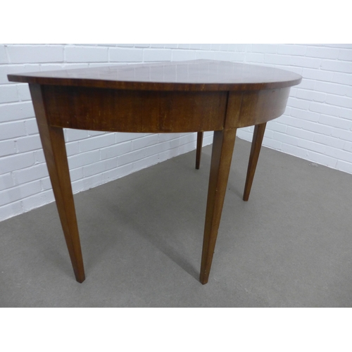 239 - Mahogany demi-lune table on tapering legs. 72 x 123 x 60cm