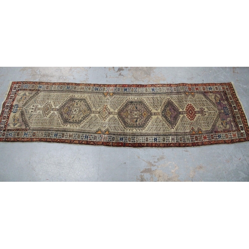 267 - Persian runner, ivory field with a pole medallion and multiple geometric borders,  warped, 310 x 85c... 