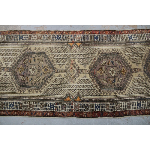 267 - Persian runner, ivory field with a pole medallion and multiple geometric borders,  warped, 310 x 85c... 