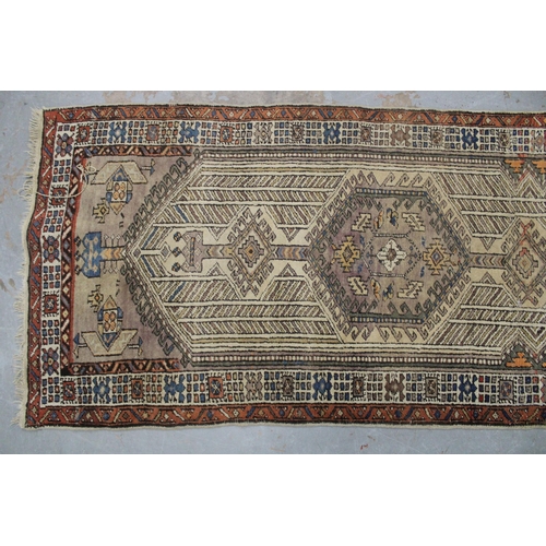 267 - Persian runner, ivory field with a pole medallion and multiple geometric borders,  warped, 310 x 85c... 