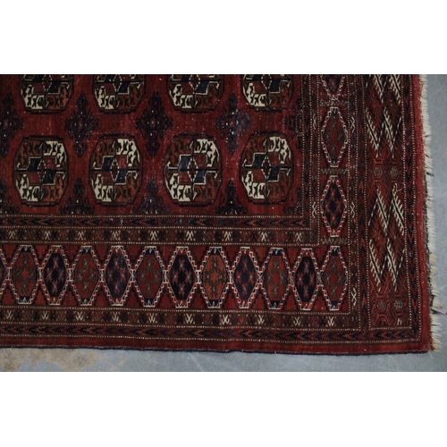 268 - Bokhara rug, red field with four rows of eight guls, 250 x 182cm