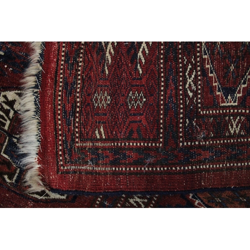 268 - Bokhara rug, red field with four rows of eight guls, 250 x 182cm