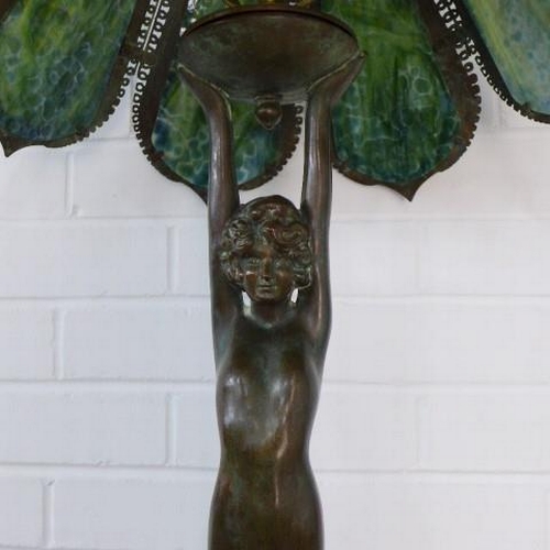 294 - Art deco style figural bronze table lamp, with a Tiffany style shade 98cm tall