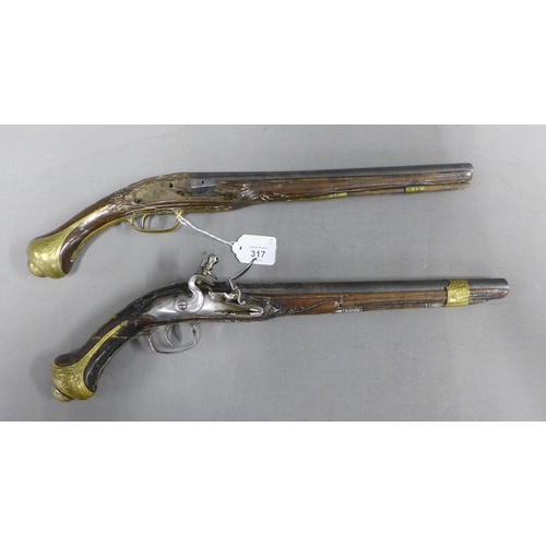 317 - Two Eastern flintlock percussion pistols, a near pair, 48.5cm overall, (a/f with losses) (2)