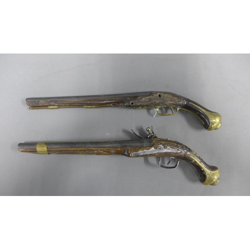 317 - Two Eastern flintlock percussion pistols, a near pair, 48.5cm overall, (a/f with losses) (2)