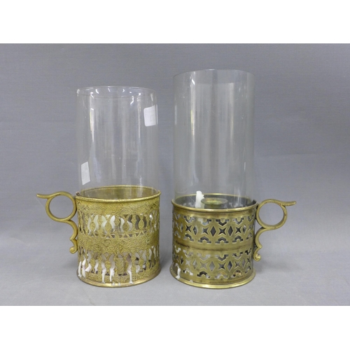 373 - Pair of pierced brass storm candle sticks with glass storm light covers, 21cm (2)