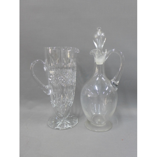 379 - Cut glass water jug and a clear glass claret jug and stopper, (2)