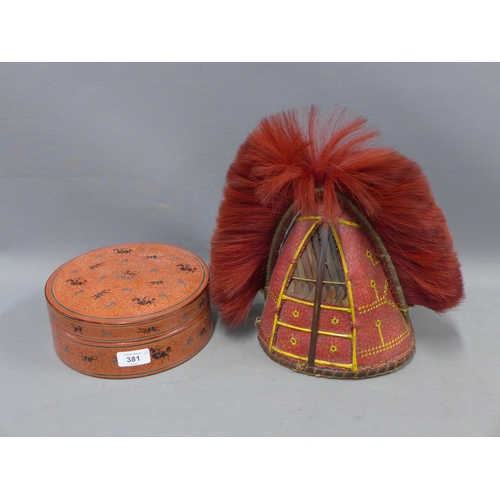 381 - Red lacquered circular box, together with a red basket weave hat with plume (2)