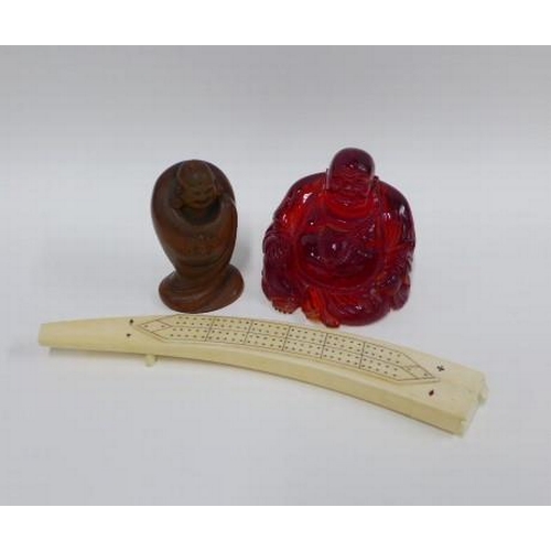 405 - Faux amber Buddha, 11cm, and a fruitwood figure together with a modern faux ivory cribbage board (3)