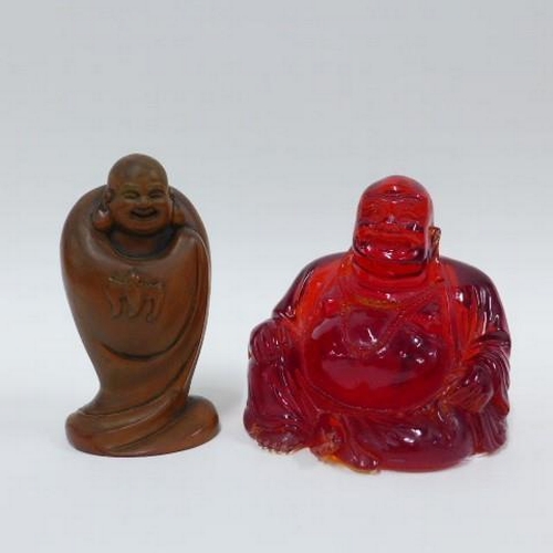 405 - Faux amber Buddha, 11cm, and a fruitwood figure together with a modern faux ivory cribbage board (3)