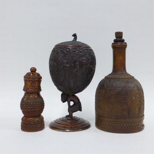 406 - Carved fruitwood castor, carved coconut goblet on figural stem and a wooden mallet, tallest 18cm (3)