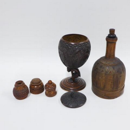 406 - Carved fruitwood castor, carved coconut goblet on figural stem and a wooden mallet, tallest 18cm (3)