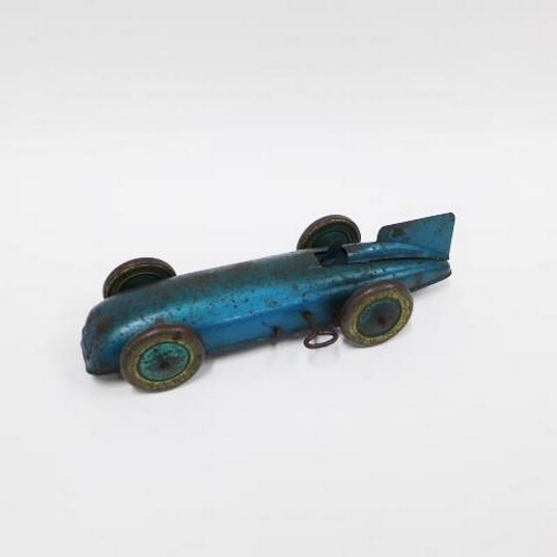 409 - Vintage tin plate model of a car and driver, 20cm long