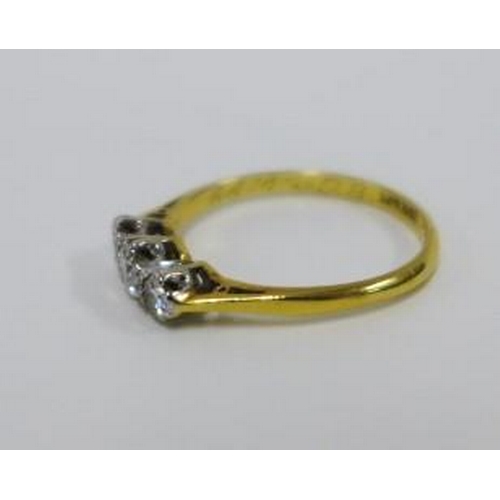 63 - Three stone diamond ring, claw set in platinum on an 18ct gold band, size O