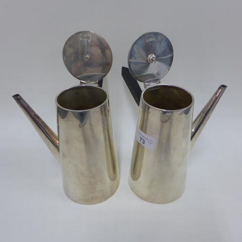 73 - Pair of early 20th century silver café au lait pots with ebonised handles, Birmingham 1911, 20cm (2)