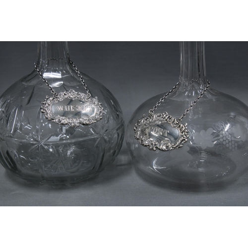 149 - Two 19th century globe and shaft decanters with stoppers together with two Irish silver decanter lab... 