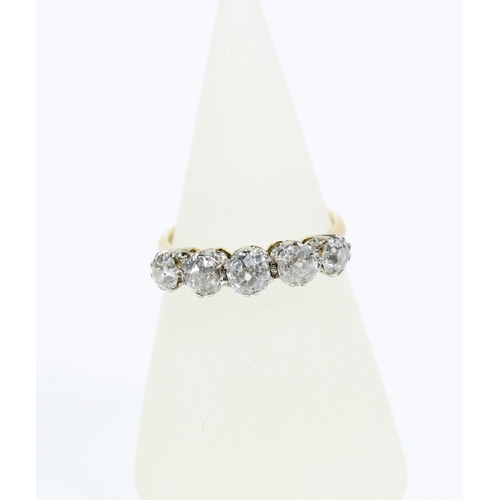 18 - An 18ct gold and platinum diamond five stone dress ring, set with graduating bright cut diamonds, ea... 