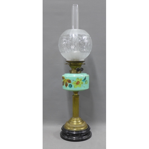 337 - Oil lamp with green glass well and brass column on an ebonised circular base, with etched glass shad... 