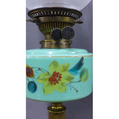 337 - Oil lamp with green glass well and brass column on an ebonised circular base, with etched glass shad... 