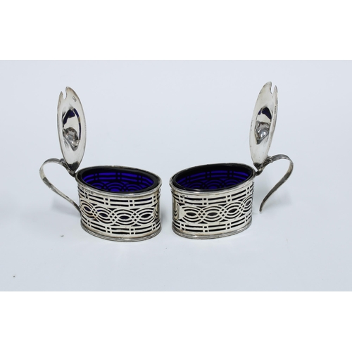 37 - George V pair of silver mustards, pierced design with blue glass liners, Chester 1912 (2)