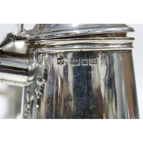 82 - Pair of George V silver café au lait pots, with domed lids and wooden handles, the spouts with hinge... 