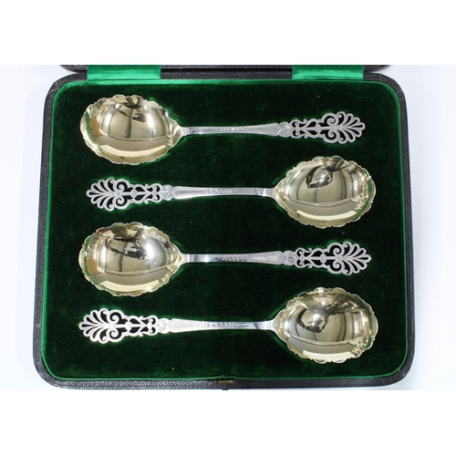 92 - Cased set of four silver gilt serving spoons, with pierced anthemion terminals and shaped bowls, She... 