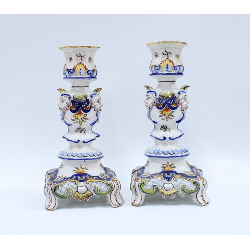 140 - A pair of faience pottery candlesticks (2) 25cm.