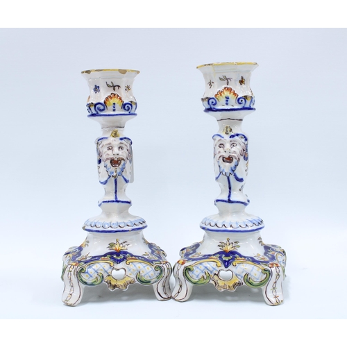 140 - A pair of faience pottery candlesticks (2) 25cm.