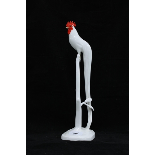 146 - Noritake model of a cockerel perched on a branch with a long trailing tail, 34cm.