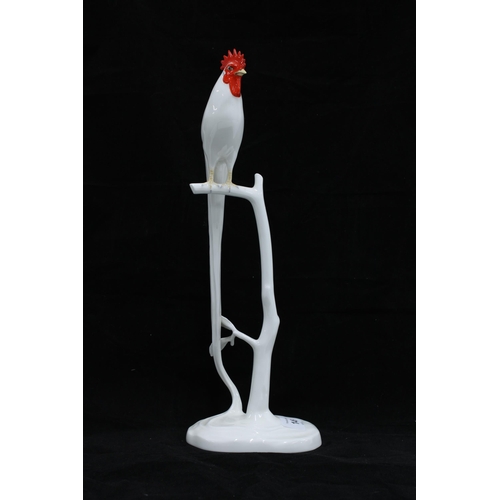 146 - Noritake model of a cockerel perched on a branch with a long trailing tail, 34cm.