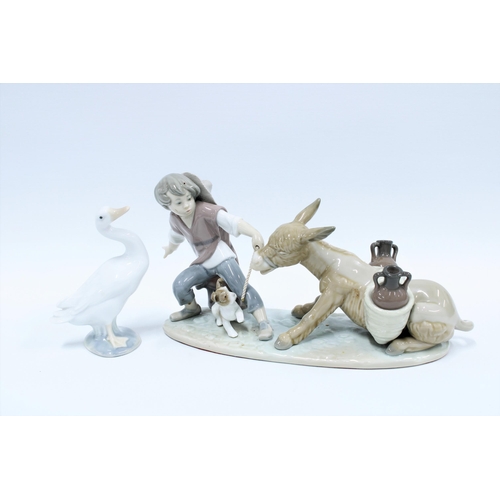 154 - Lladro figure group of a boy with a donkey and puppy together with a Lladro goose (2) 30cm.