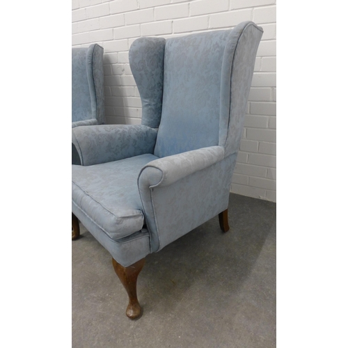 206 - Pair of wingback armchairs with pale blue damask style upholstery, on cabriole legs (2).