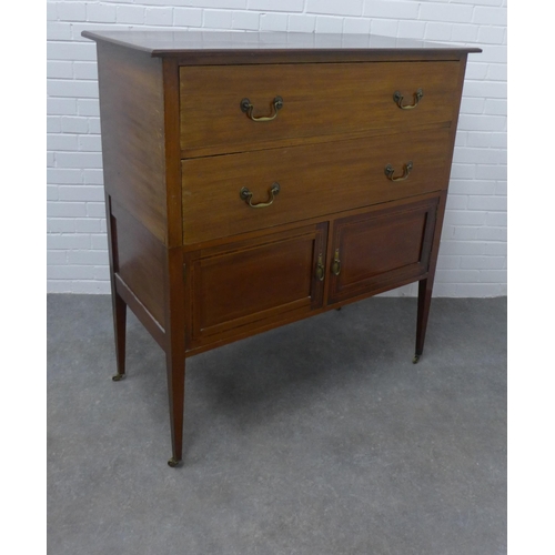 210 - Edwardian mahogany chest, the rectangular top above two long drawers and pair of cupboard doors on s... 