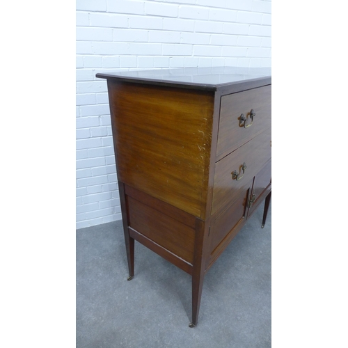 210 - Edwardian mahogany chest, the rectangular top above two long drawers and pair of cupboard doors on s... 