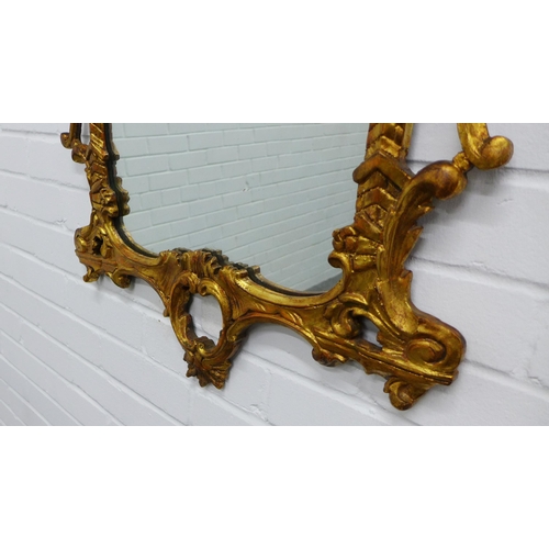 222 - Rococo style gilt framed wall mirror. 109 x 59cm.