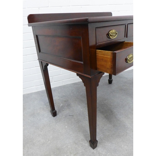 224 - Mahogany ledge back desk with five drawers, brass handles and square tapering legs with spade feet .... 