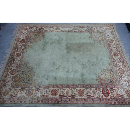 239 - Large pale green carpet with central medallion and flowerhead border, 414 x 324cm (a/f)