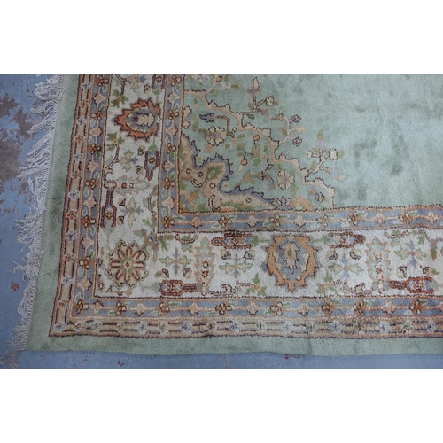 239 - Large pale green carpet with central medallion and flowerhead border, 414 x 324cm (a/f)