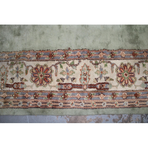 239 - Large pale green carpet with central medallion and flowerhead border, 414 x 324cm (a/f)