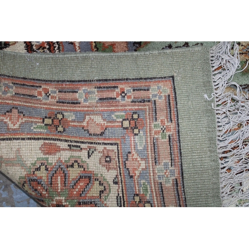 239 - Large pale green carpet with central medallion and flowerhead border, 414 x 324cm (a/f)