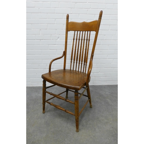 256 - An Arts & Crafts oak spindle back chair in the manner of William Birch, . 109 x 50 x 42cm.