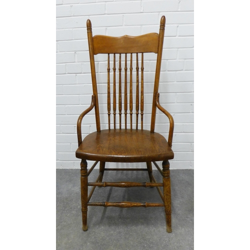 256 - An Arts & Crafts oak spindle back chair in the manner of William Birch, . 109 x 50 x 42cm.