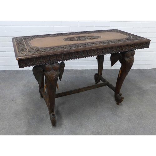 280 - Early 20th century Indian carved hardwood table on elephant head supports,  73 x 122 x 58cm. (a/f)