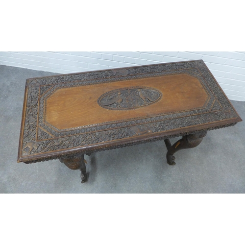 280 - Early 20th century Indian carved hardwood table on elephant head supports,  73 x 122 x 58cm. (a/f)