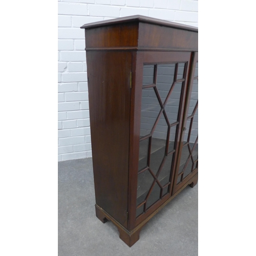 291 - Mahogany glazed cabinet with two glazed doors and shelved interior on bracket feet. 100 x 77 x 30cm.